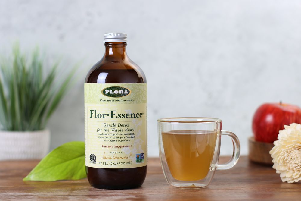 Woman drinking Flor-Essence herbal tea cleanse from Flora Health for gentle detoxification and cellular health