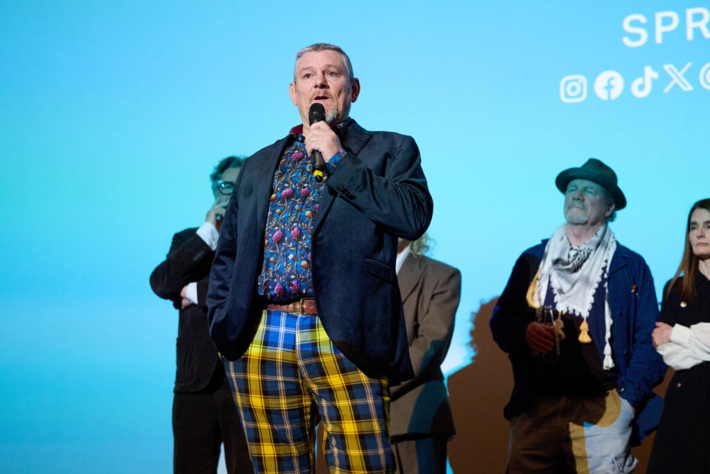 John Davidson speaks on stage during the London gala screening of