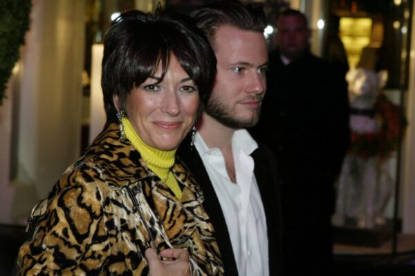 Socialite Ghislane Maxwell with an unidentified male companion attends the Opening of the Asprey Flagship Store on 5th Avenue December 8, 2003 in New York City.