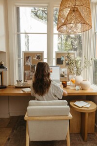 camille Styles working at desk