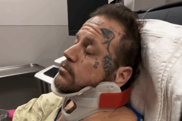 Jelly Roll in a neck brace in a hospital bed in January 2026.