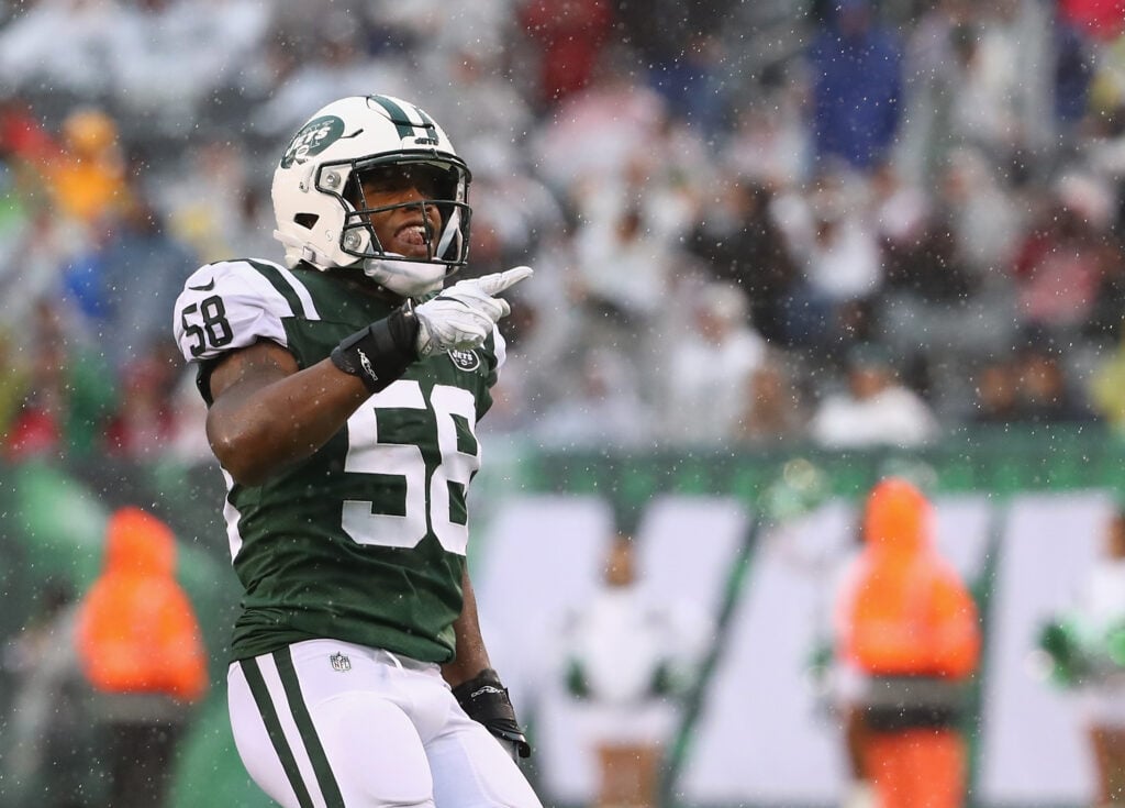 Inside linebacker Darron Lee #58 of the New York Jets celebrates a recovery by teammate  Jordan Jenkins #48 in the first quarter against the Atlanta Falcons at MetLife Stadium on October 29, 2017 in East Rutherford, New Jersey.