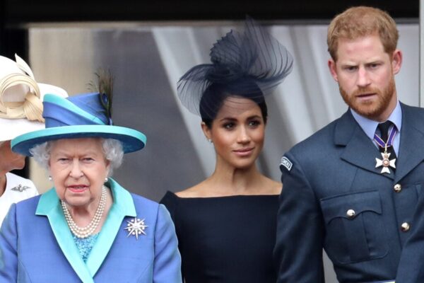 Queen Elizabeth II, Prince Harry, Duke of Sussex and Meghan, Duchess of Sussex on the balcony of Buckingham Palace as the Royal family attend events to mark the Centenary of the RAF on July 10, 2018 in London, England.