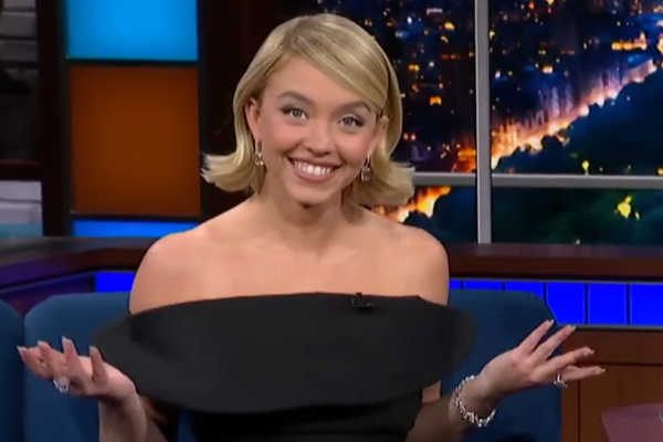 Sydney Sweeney smiles and shrugs on Colbert.