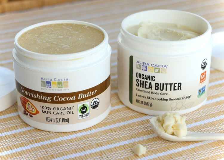 Jar of Aura Cacia Organic Shea Butter next to cocoa butter, ingredients for DIY citrus mint body butter recipe