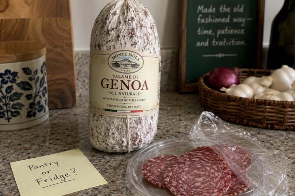 sliced salami and a whole salami on a counter