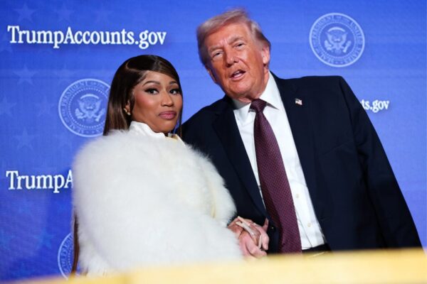 Musician Nicki Minaj joins U.S. President Donald Trump on stage as he delivers remarks during the Treasury Department