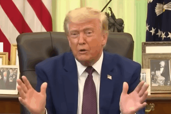 Donald Trump appears to play an imaginary accordion in the oval office.