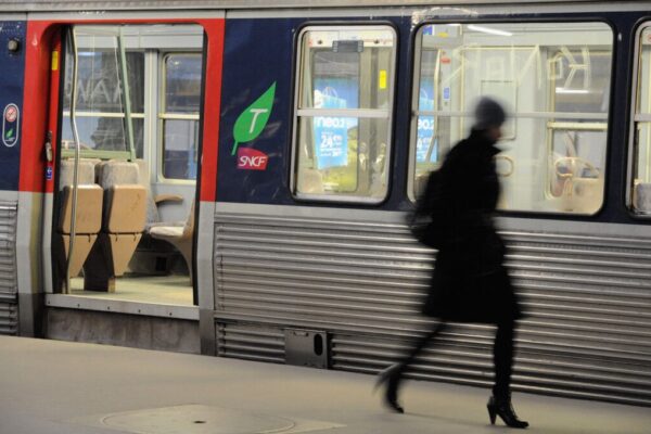 A commuter walks on a platform to catch her train at Paris Saint Lazare railway station on January 29, 2009 in Paris, France.