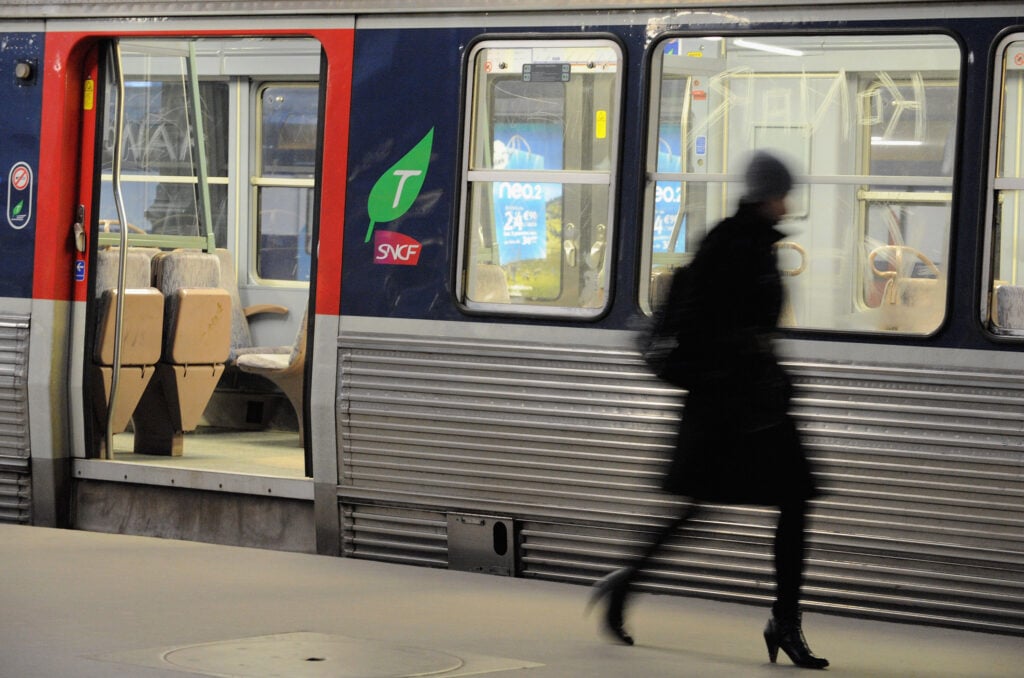 A commuter walks on a platform to catch her train at Paris Saint Lazare railway station on January 29, 2009 in Paris, France.
