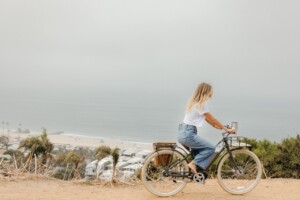 Woman riding bike outside.