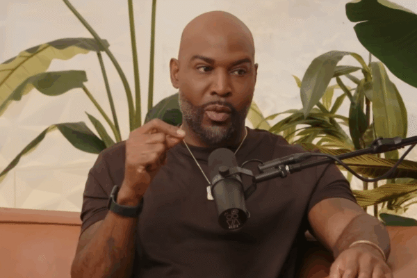 Karamo Brown speaks on a podcast.