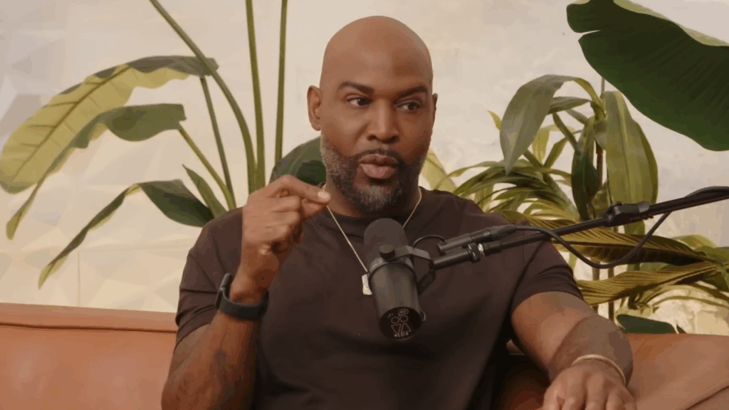 Karamo Brown speaks on a podcast.