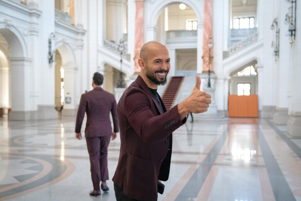 Andrew Tate (left) poses for a photo while entering the Court of Appeal on October 15, 2024 in Bucharest, Romania.