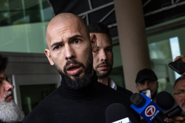 Andrew Tate (L) and Tristan Tate (R) arrive in the United States after a travel ban on them was lifted, at the Fort Lauderdale-Hollywood International Airport on February 27, 2025 in Fort Lauderdale, Florida.