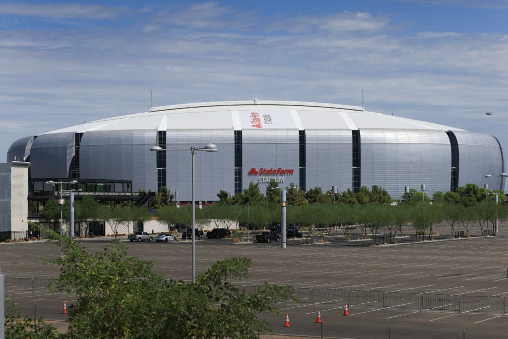 A Marine Helicopter Squadron One (HMX-1)(far right) prepares to fly past the State Farm Stadium, home of the Arizona Cardinals.