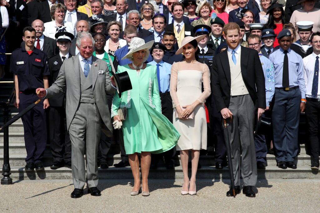 Prince Harry, Duke of Sussex, Prince Charles, Prince of Wales, Camilla, Duchess of Cornwall, Meghan, Duchess of Sussex and guests pose for a photograph as they attend.